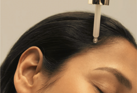 Application of a targeted serum to the scalp, illustrating how peptides for hair growth penetrate and stimulate healthier, denser hair.