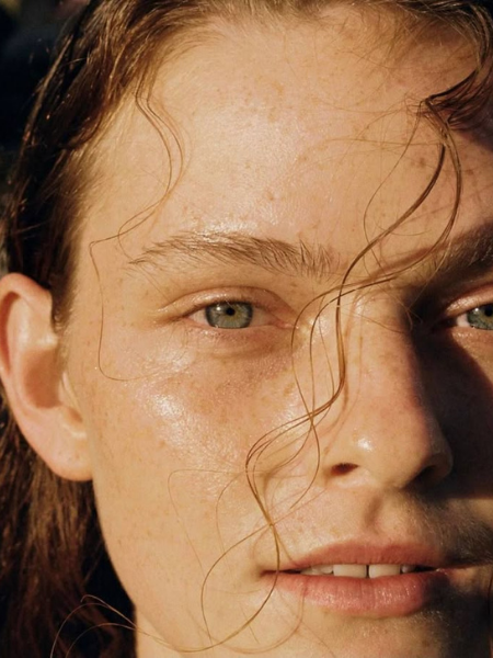 Close-up portrait showing natural skin texture and hair strands, symbolizing scalp vitality and the effects of peptides for hair growth.